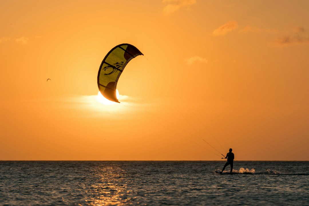 Kitesurfeur au coucher du soleil sur une mer calme